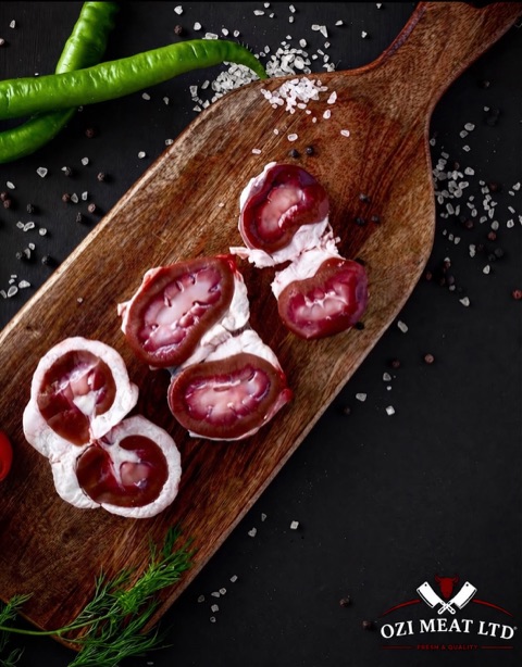 Trimmed lamb kidneys on a wooden board